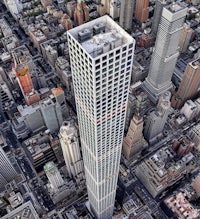 an aerial view of a tall building in a city