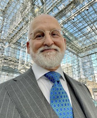 a man in a suit and tie standing in front of a building